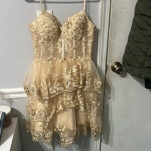 I am selling a Wchecalino dress, the color is gold. With a beautiful open back.
